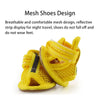 A pair of bright yellow mesh shoes designed for night travel and comfort.