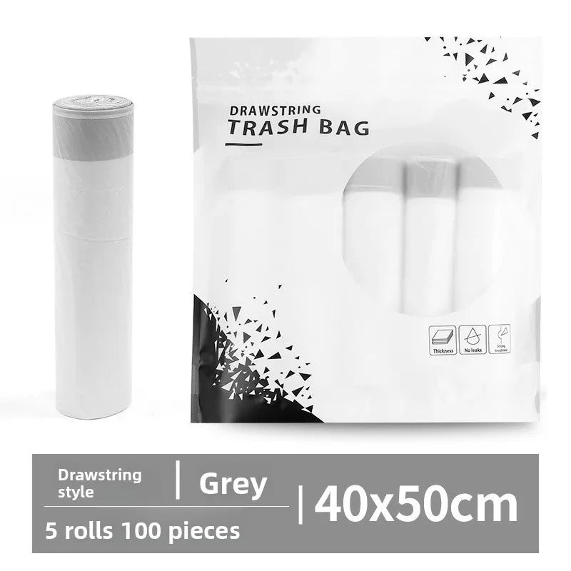 Packaged drawstring trash bags in white with a grey label showing dimensions and features