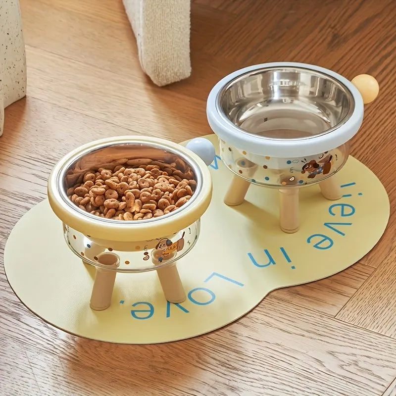 A yellow elevated stainless steel double pet bowl with a stand sits on a wooden surface.