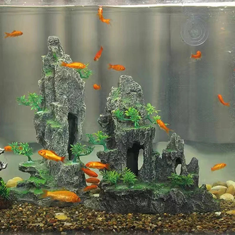 Resin aquarium rockery featuring a cave structure, trees, and orange fish in an aquarium setting.