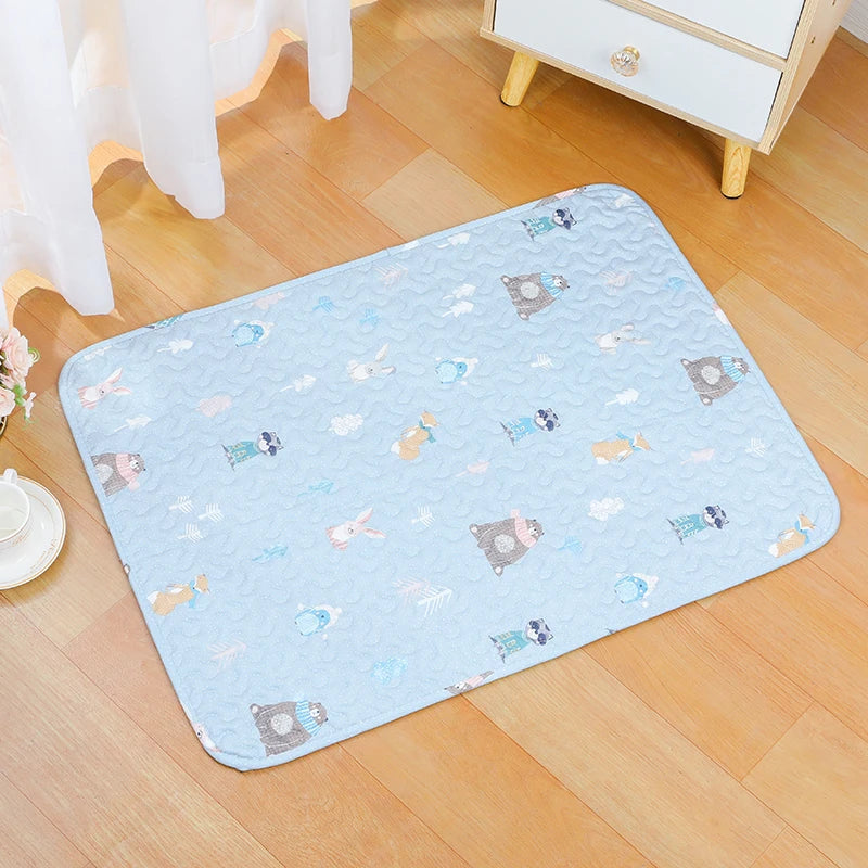 Light blue soft cotton pet cage mat with a non-slip base placed on a wooden floor.