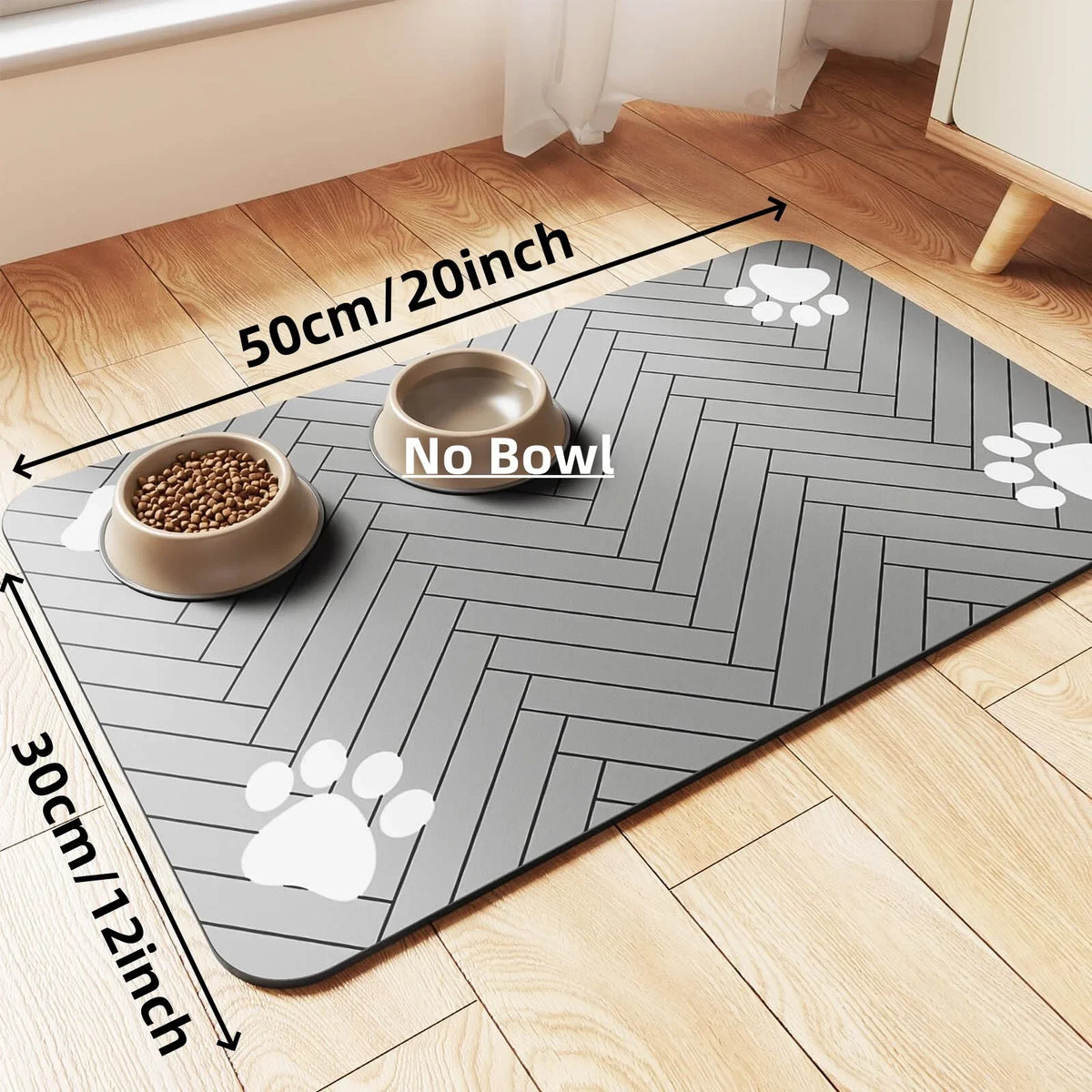 A gray absorbent pet feeding mat with a herringbone pattern and paw prints, showing a bowl on the mat.
