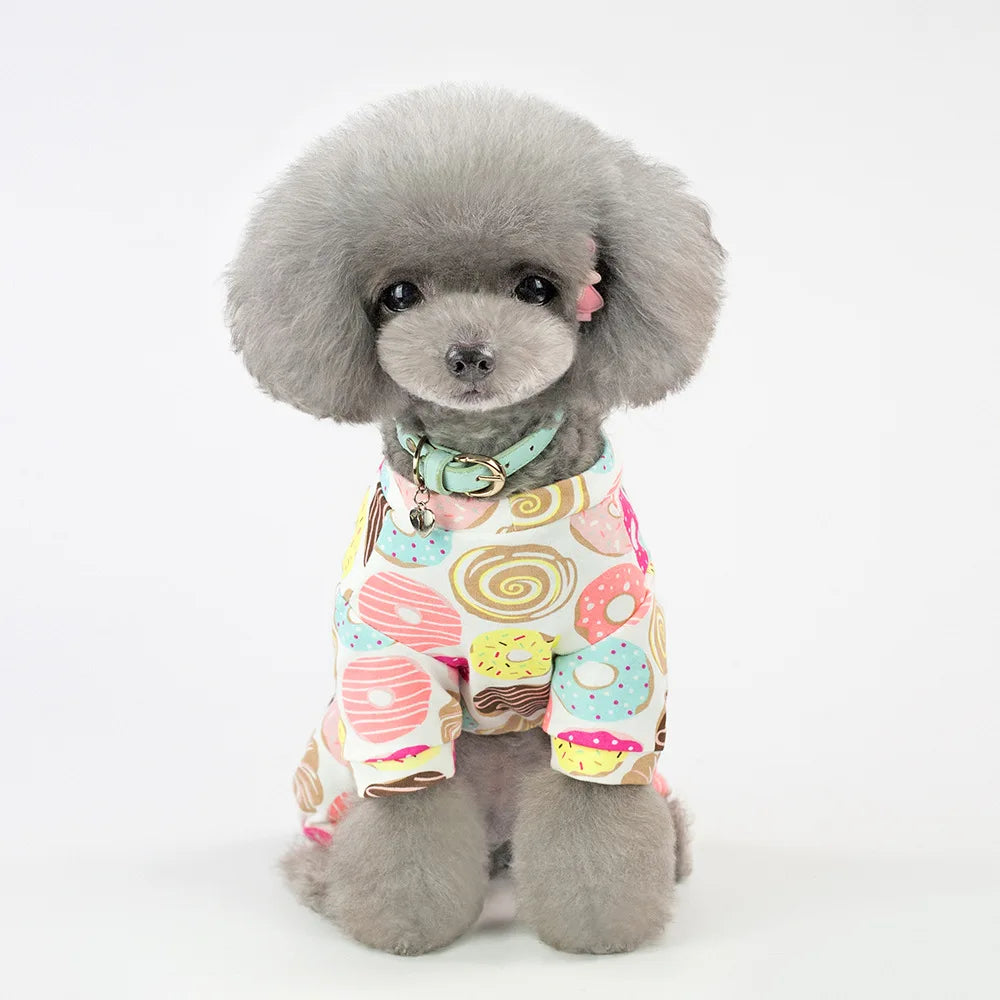 A fluffy gray poodle wearing a colorful patterned cotton pet pajama top.