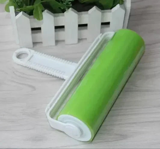 A bright lime green reusable lint roller is shown next to a white picket-style storage box.