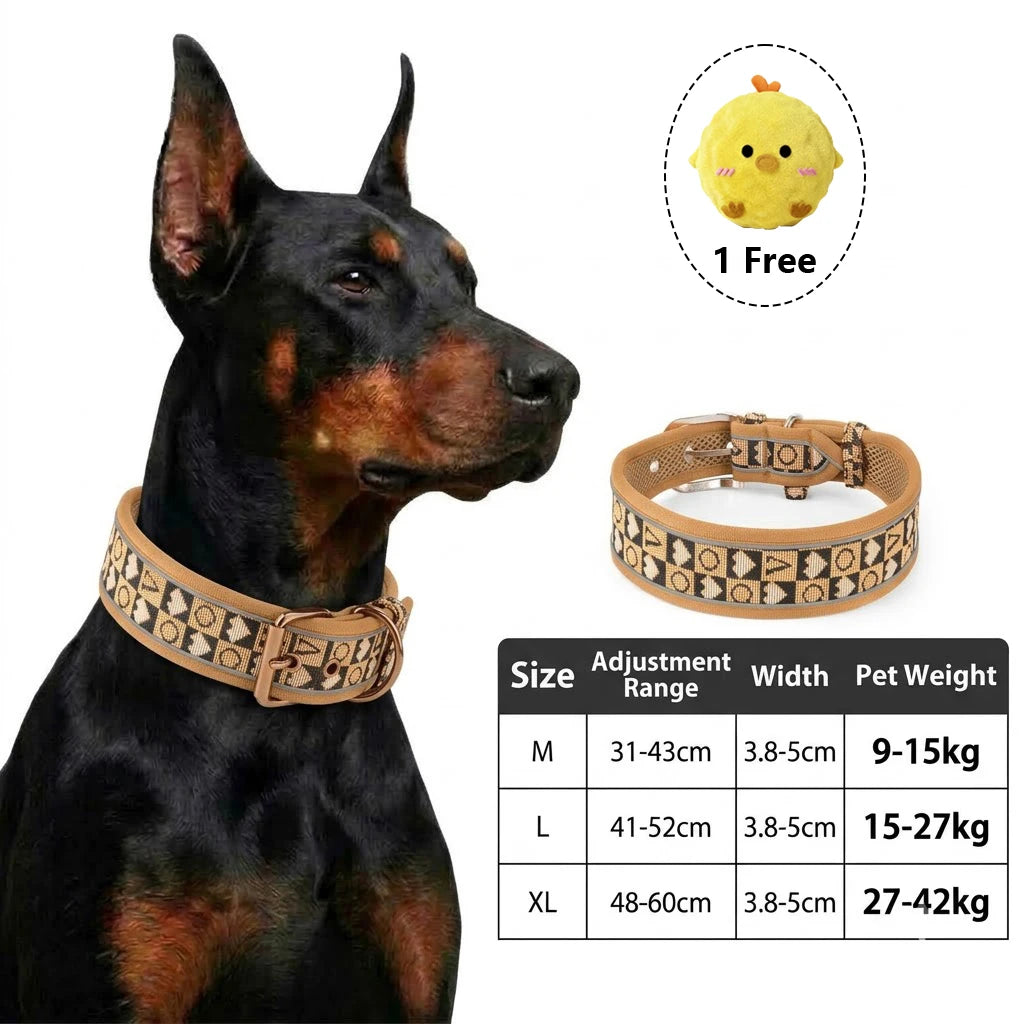A black dog wearing an adjustable tactical harness with reflective trim, next to a yellow toy.