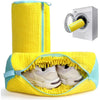 A yellow fabric bag designed to hold shoes for washing in a machine, next to a white washing machine.