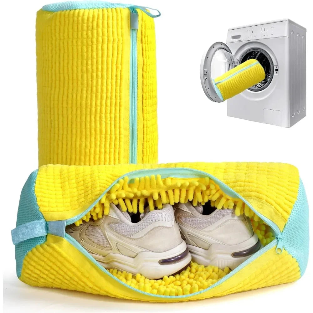 A yellow fabric bag designed to hold shoes for washing in a machine, next to a white washing machine.