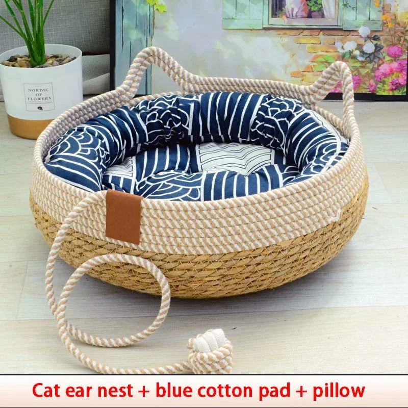 Woven rattan cat nest with a blue cotton pad and pillow for a pet.