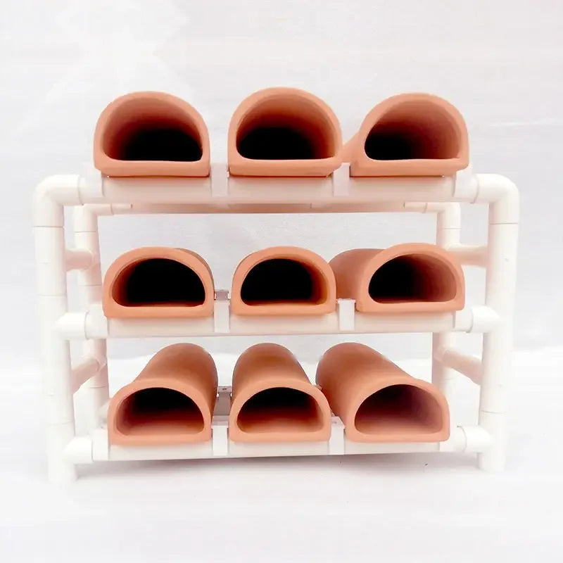 A white ceramic aquarium breeding cave with multiple orange-colored shrimp shelters.