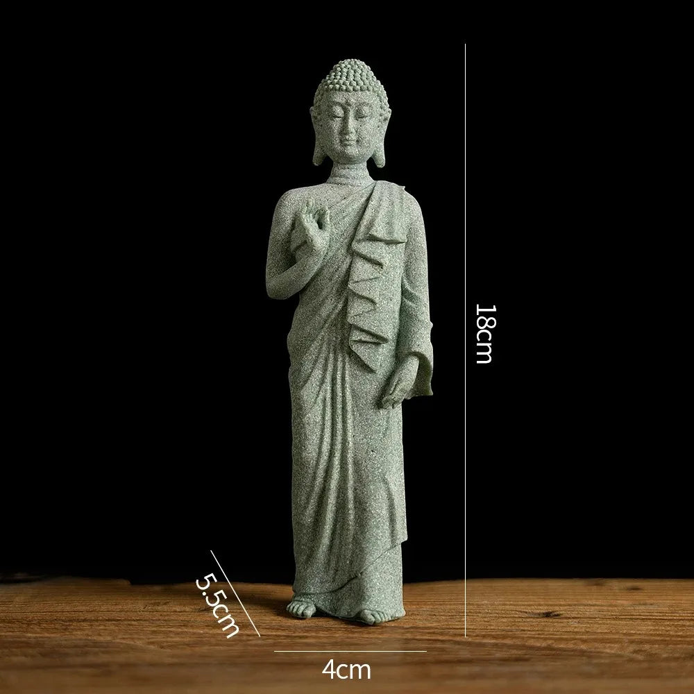 A small, light gray Buddha stone statue with a serene expression, displayed on a wooden surface.