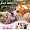 A dog is drinking water from a pink portable stainless steel bottle designed for on-the-go hydration.