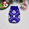 A navy blue knitted sweater featuring a white pattern of panda faces and snowflakes, displayed with Christmas decorations.