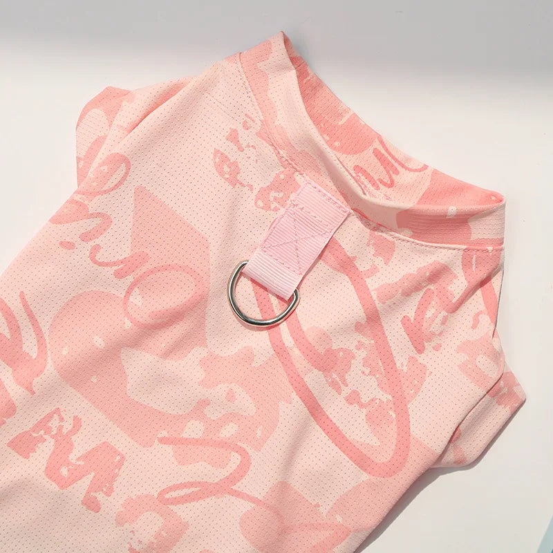 A pink ice silk cooling vest for dogs or cats, featuring a printed design and a pink strap.