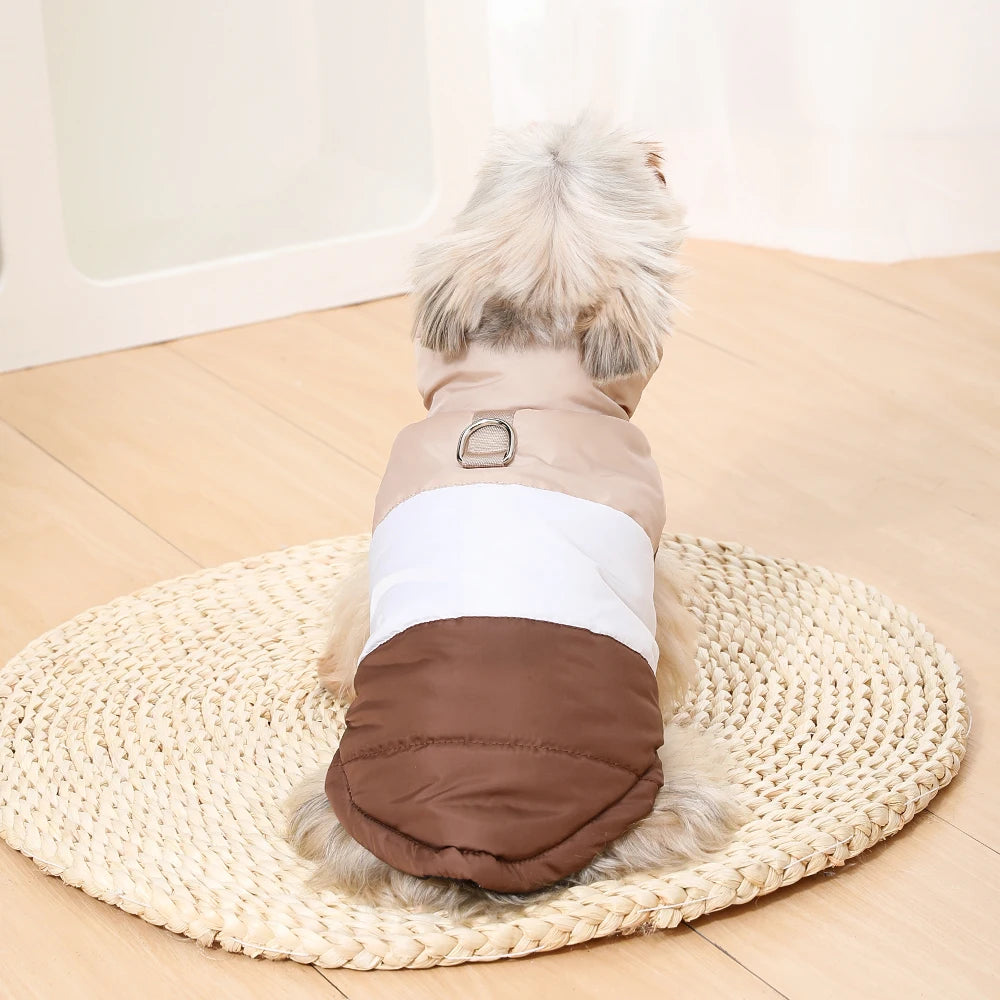 A padded windproof dog vest with a D-ring for small breeds shown lying on a woven mat.