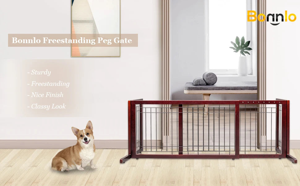 A brown wooden pet gate with vertical bars is shown in a bright room, next to a large mirror and a dog.