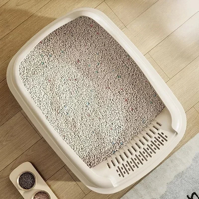 Arenero compacto de bordes altos para gatos