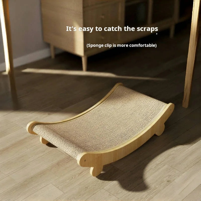 A natural fiber sisal cat scratcher and lounge bed is placed on a wooden floor.
