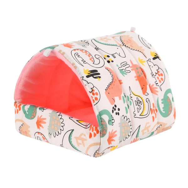 A cozy cartoon pet nest bed with a pink interior and a white fabric featuring cute dinosaur and animal patterns.