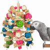A gray parrot is interacting with a natural wooden parrot bite toy made of woven straw and colorful foam pieces.