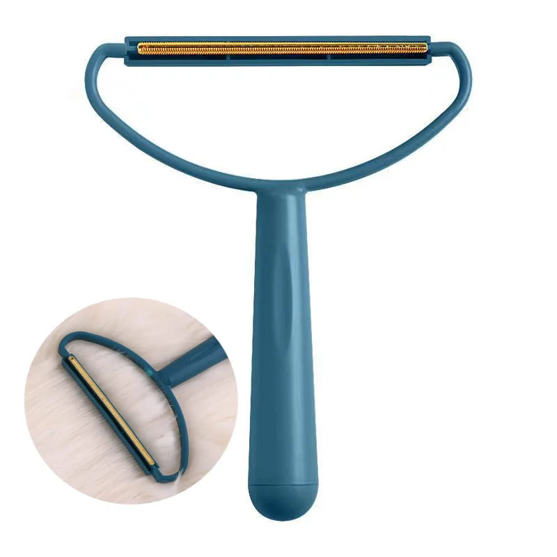 A teal portable fabric and pet hair remover brush with a flexible handle and a bristled head.