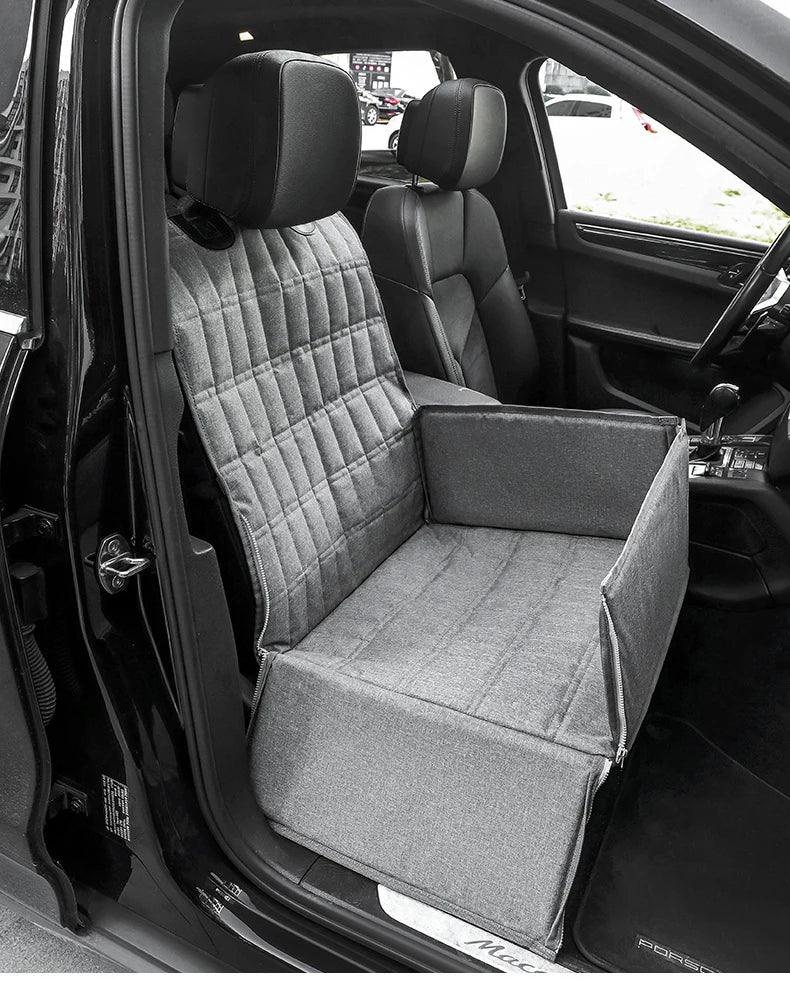 A gray waterproof dog car seat hammock installed in the back seat of a black vehicle.