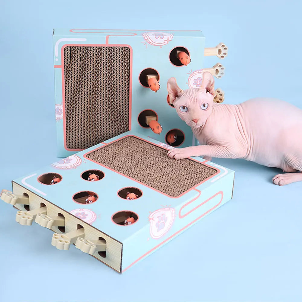 A pink cat is interacting with an interactive whack-a-mole style scratching board designed for cats.