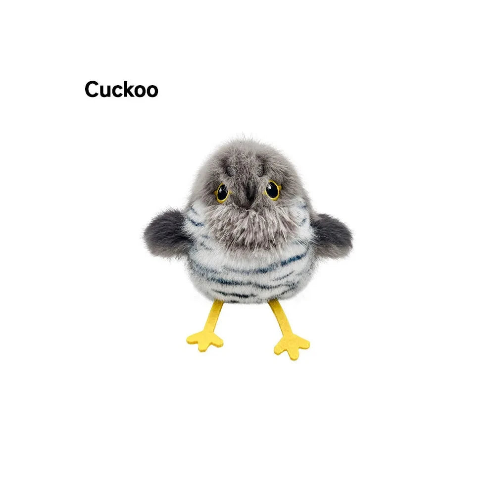 A fluffy gray and white bird toy with yellow feet, designed for interaction.