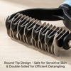 Close-up of a black pet detangling comb with round-tip design resting on a light wooden surface.