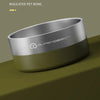 A silver insulated pet bowl with a smooth finish and a matte olive green base is shown on a dark surface.
