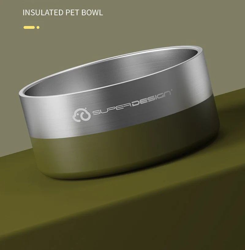 A silver insulated pet bowl with a smooth finish and a matte olive green base is shown on a dark surface.