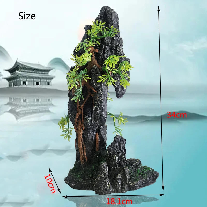 A dark resin aquarium rockery featuring a cave structure and tree, shown with dimensions of 34cm height and 18.1cm base.