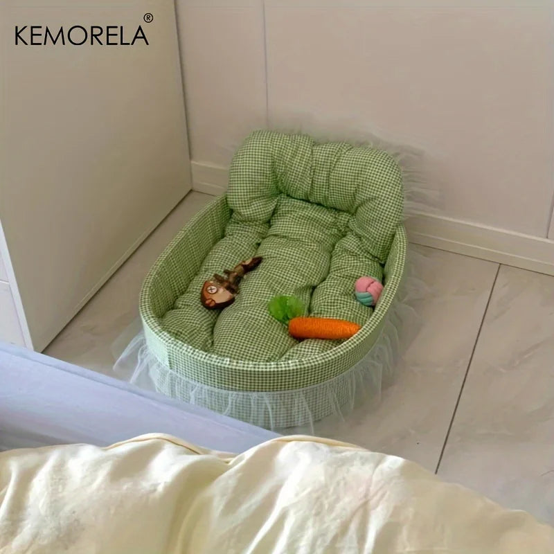 A light green gauze-trimmed pet bed mat with a quilted interior is shown on a white floor.
