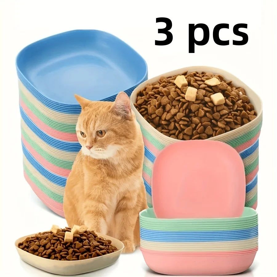 A set of three non-slip shallow cat bowls for kittens and small pets, featuring terracotta-colored food, pink, and striped bo