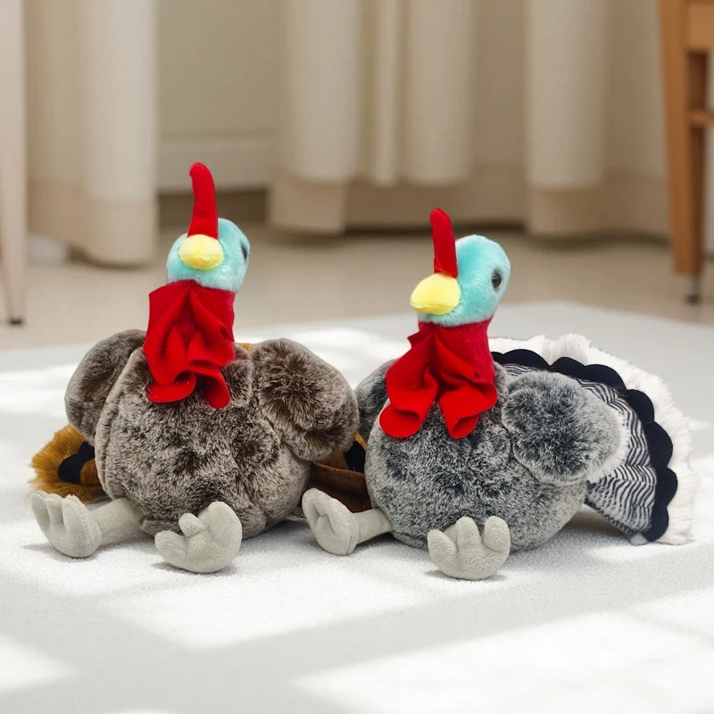 A pair of lifelike plush rooster and hen pillows with red combs and feathers resting on a white surface.