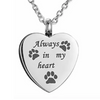 A silver heart-shaped stainless steel necklace with paw prints engraved on it.