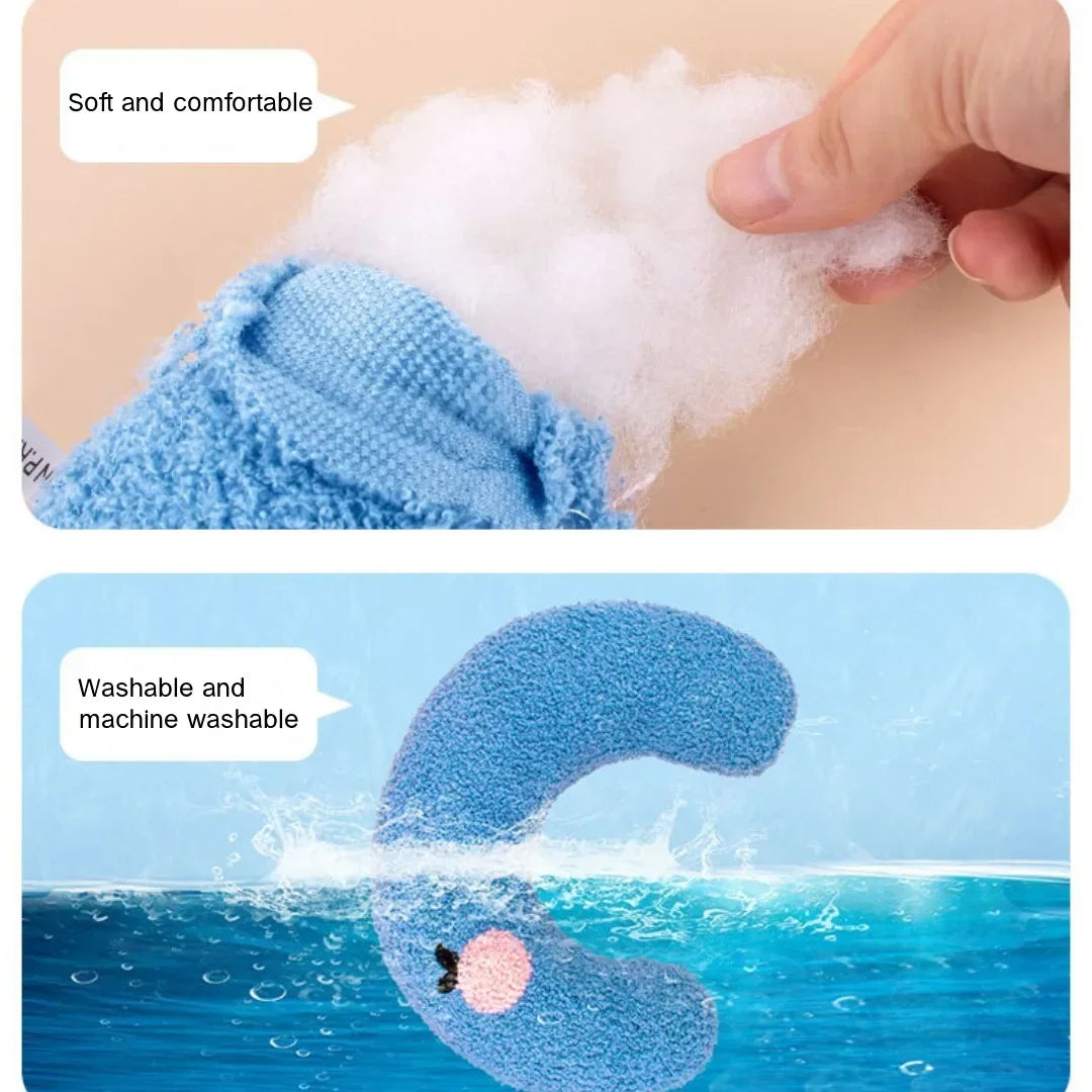 A blue U-shaped cat sleeping pillow is shown being washed in the ocean water.