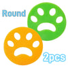 Two round silicone lint rollers, one green and one orange, for removing pet hair or lint.