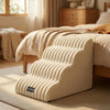 A beige pet safety ladder or step aid for dogs and cats resting on a wooden bed frame.