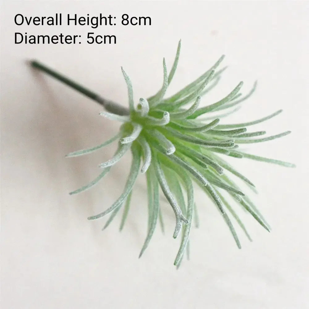 A green flocked artificial succulent plant with a long stem and numerous thin, spiky leaves.