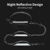 A black night reflective design retractable leash for dogs shown against a dark background.