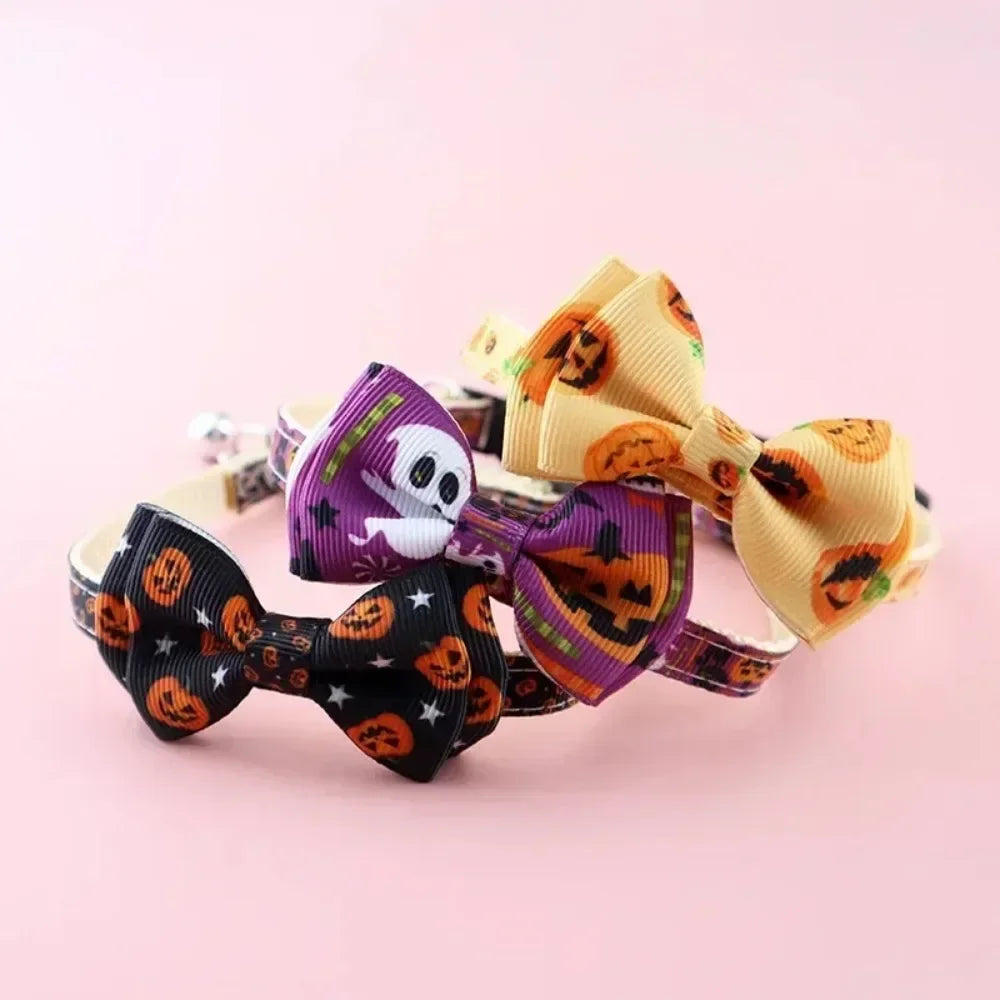 Halloween cat collar with a purple skull bow tie and an orange bow tie on a pink background