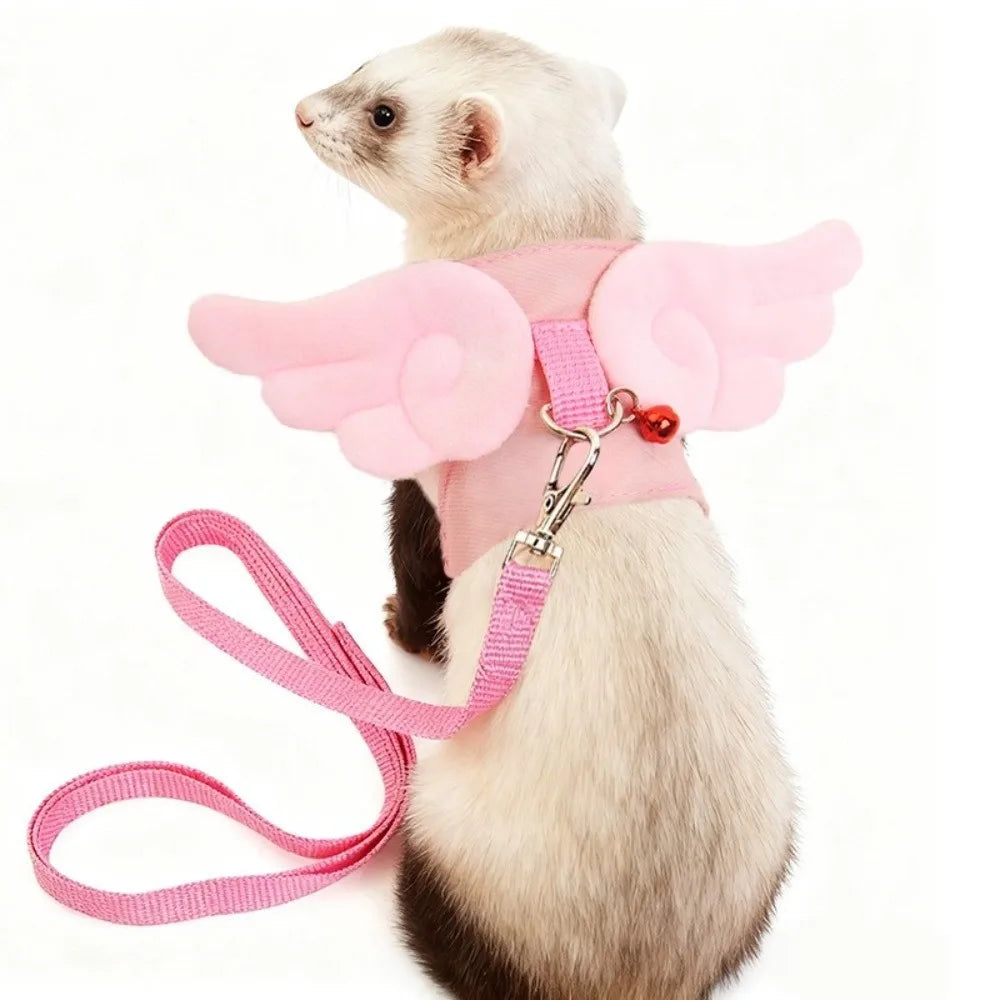 A light gray pet harness with pink wings and a pink leash, worn by a small rodent.
