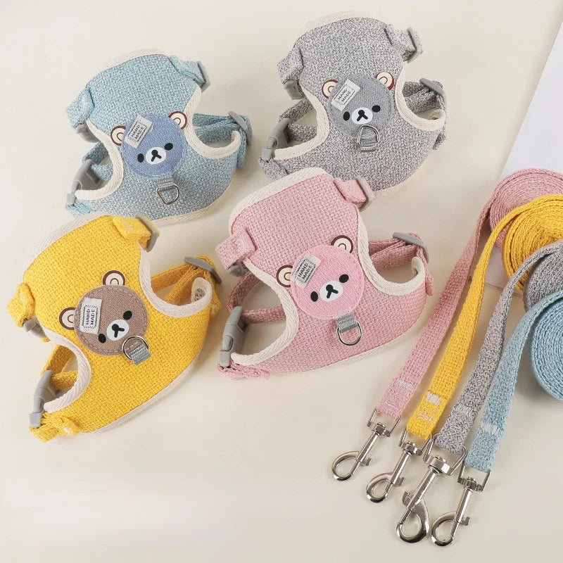 A collection of adjustable nylon dog harnesses and leashes in various colors including blue, gray, pink, and yellow.