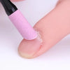 A pink glitter nail file tool is being used to apply product to a person's fingernail.