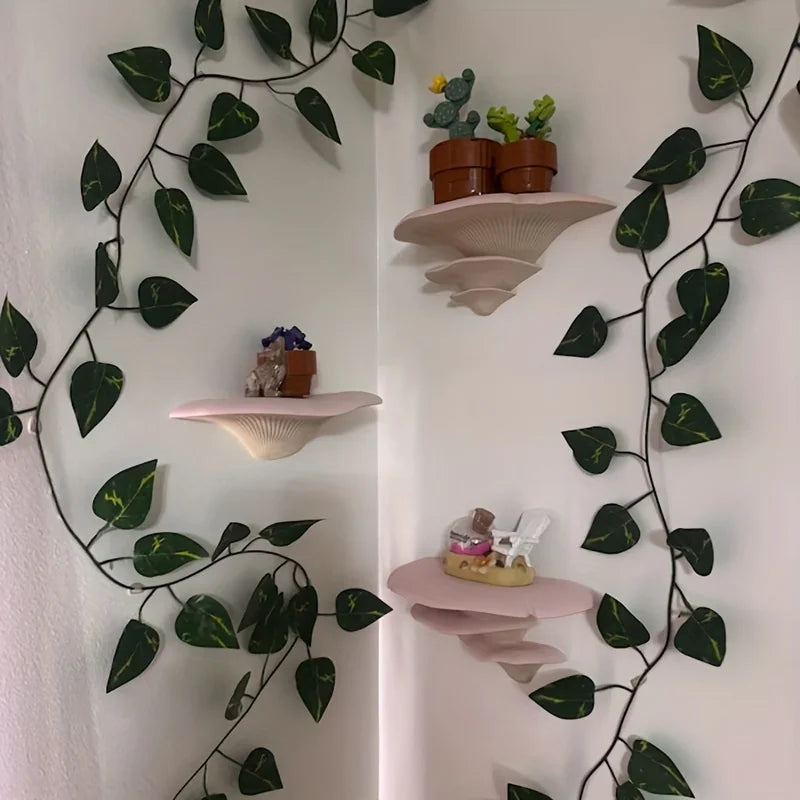 A decorative mushroom-shaped storage rack with a wall mount option featuring small potted plants.