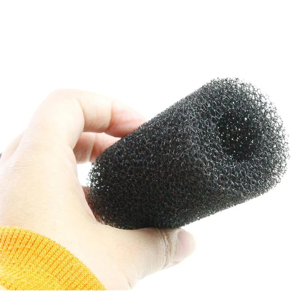 A hand is holding a black aquarium pre-filter sponge for tank intake protection.