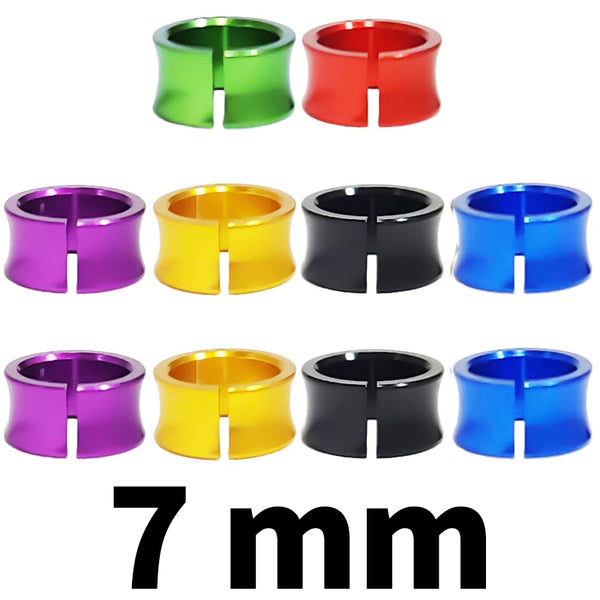 Assorted metal bird identification rings in green, red, purple, yellow, black, and blue.