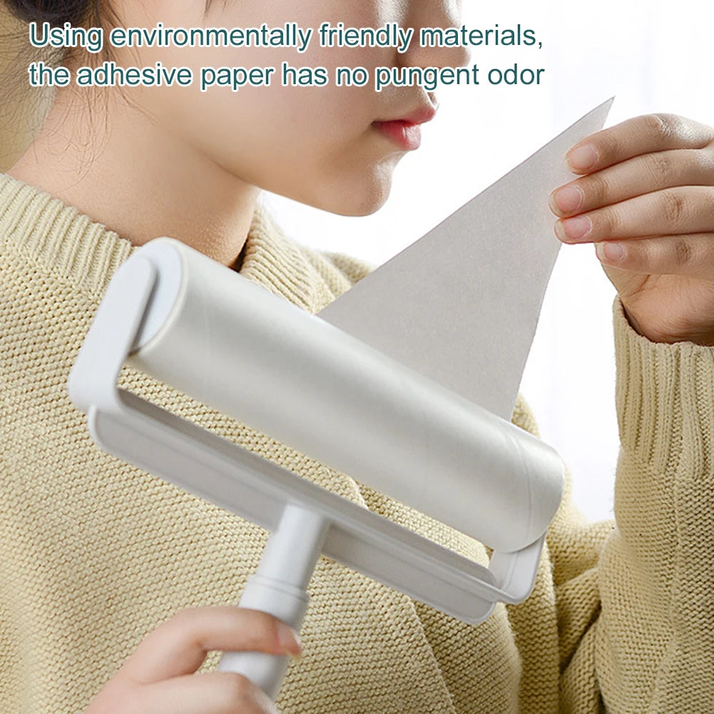 A person is using a white multipurpose tearable lint roller with a long extendable handle.