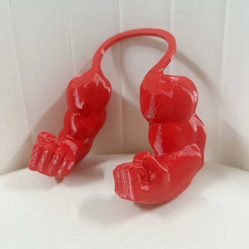 A red 3D printed accessory shaped like a cat muscle arm.