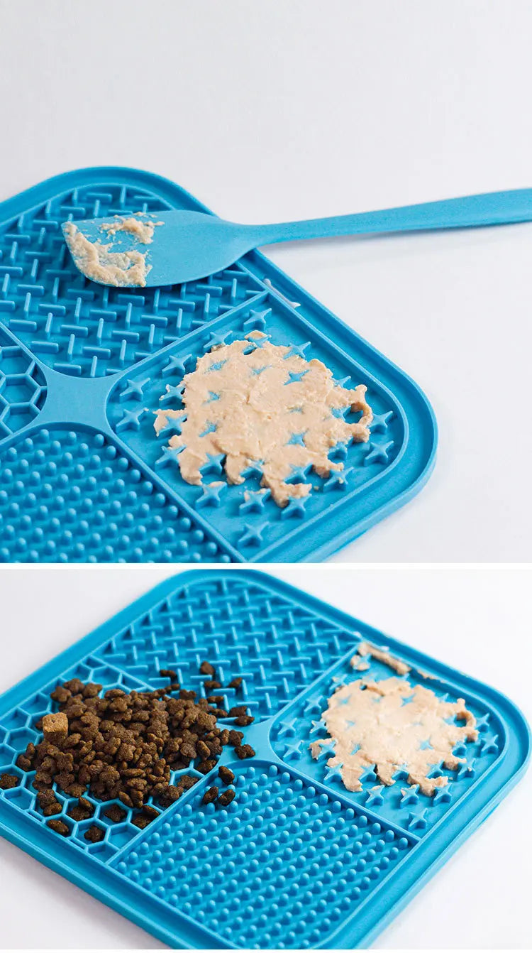 A blue silicone pet licking mat with suction cups showing a portion of light-colored food on the surface.